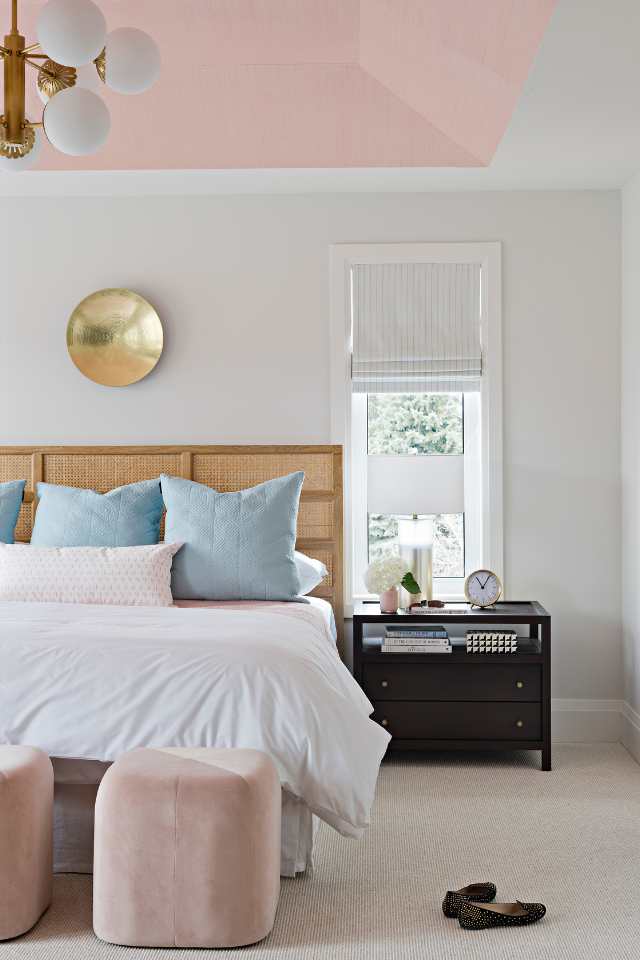 blush pink bedroom with plush carpeting and gold and blue accents