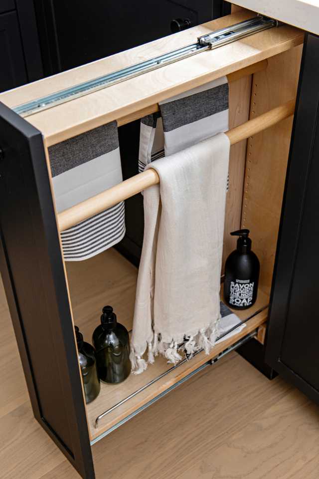 custom built drawer compartment for cleaning supplies and towels